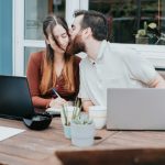 married couple discussing merging bank accounts
