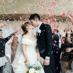 wedding couple standing in the middle of a confetti celebration