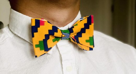 bold yellow blue and green print bow tie outfit idea for men's engagement photo shoot
